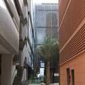 Buildings at Masdar incorporate numerous material and construction strategies for minimizing heat gain including metal screening, terracotta cladding and air-filled wall panels. Image © Tyler Caine Buildings at Masdar incorporate numerous material and construction strategies for minimizing heat gain including metal screening, terracotta cladding and air-filled wall panels. Image © Tyler Caine