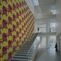 Staircase to 2nd floor with Andy Warhol’s Cow wallpaper in the Education and Research Building. Image © Timothy Hursley 