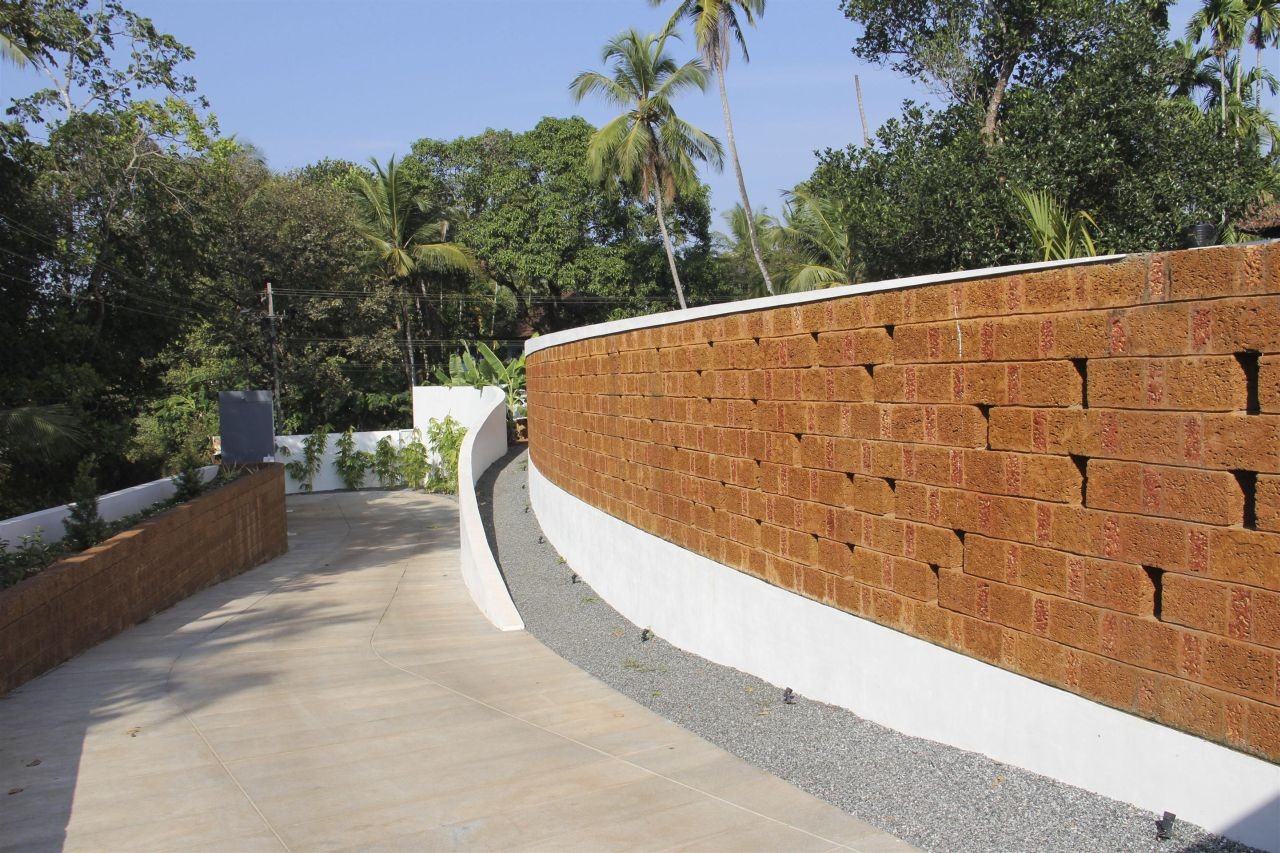 Gallery of The Running Wall Residence / LIJO RENY ...