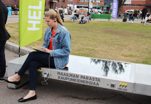 One of five Ecotap Solar Benches installed in Helsinki by Helen. The bench, which stores solar power, can be used to charge mobile devices and electric bicycles. The benches are part of the mySMARTLife EU project to cut urban carbon dioxide emissions. Photo attribution: Helmi Carpén / Helen One of five Ecotap Solar Benches installed in Helsinki by Helen. The bench, which stores solar power, can be used to charge mobile devices and electric bicycles. The benches are part of the mySMARTLife EU project to cut urban carbon dioxide emissions. Photo attribution: Helmi Carpén / Helen