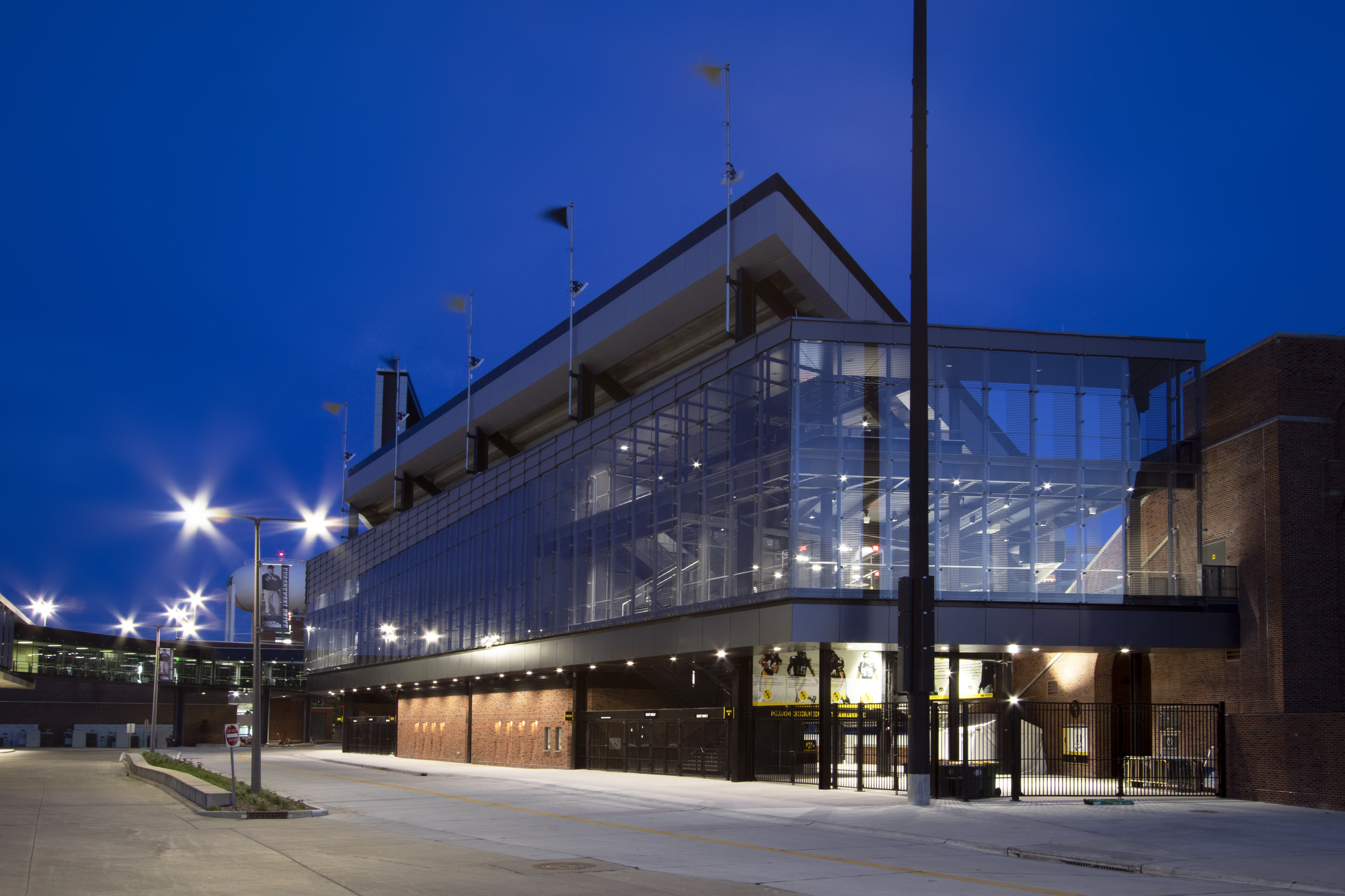 Gallery of How to Construct a Stadium Facade from Custom Glass While on