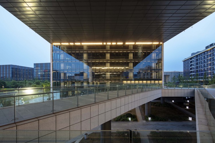 Office space with lights on. Image Courtesy of Aedas
