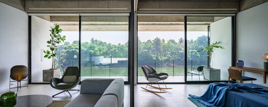 The House That Meets the River / LIJO RENY architects - Interior Photography, Living Room, Glass, Chair
