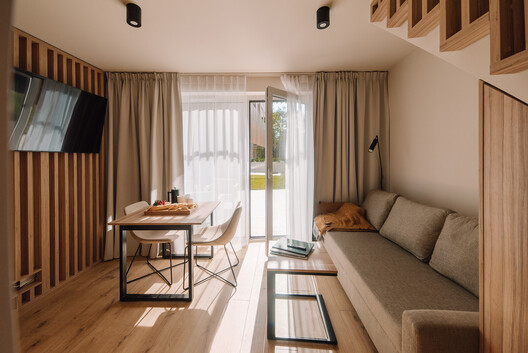 Baltycki Apartments / Maxberg - Interior Photography, Living Room, Wood, Lighting, Sofa, Bed