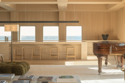 Transforming a Concrete Shell into a Wooden Interior Shaped by the Sea - Image 11 of 15