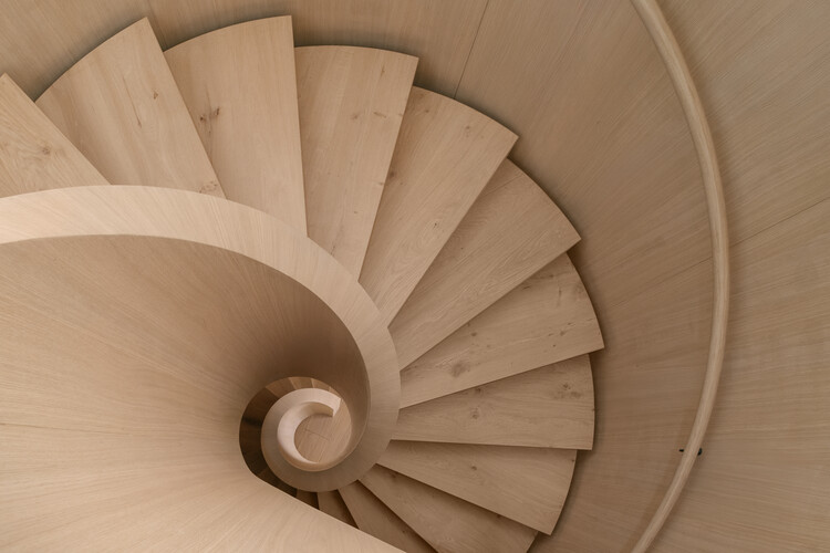 Transforming a Concrete Shell into a Wooden Interior Shaped by the Sea - Featured Image