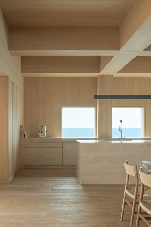 Transforming a Concrete Shell into a Wooden Interior Shaped by the Sea - Image 5 of 15