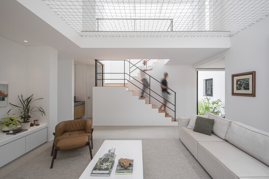 Piná House / Nommo Arquitetos - Interior Photography, Living Room, Stairs, Handrail, Chair
