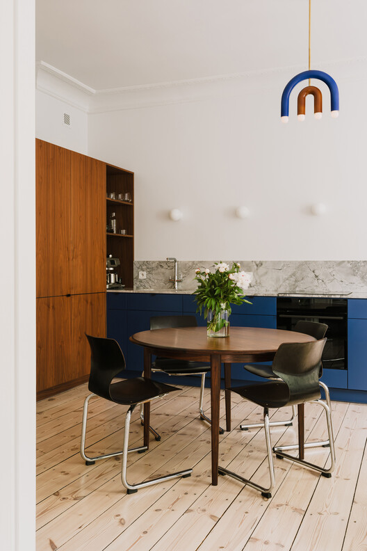 Apartment Interior within Poznań's Łazarz District / LBWA Apartment Interior within Poznań's Łazarz District / LBWA - Interior Photography, Dining room, Wood, Table, Lighting, Chair