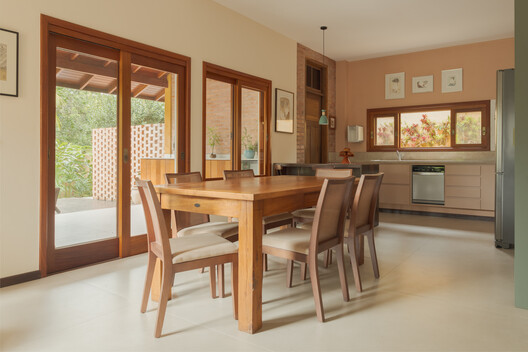 Jardim House Renovation / Baixo Impacto Arquitetura - Interior Photography, Dining room, Table, Chair, Wood, Door, Lighting