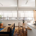Caju Apartment / CODA Arquitetura - Interior Photography, Apartment Interiors, Kitchen, Lighting, Table, Chair, Countertop