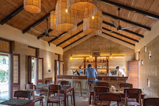 Tiger Track Ecolodge / Building Bureau - Interior Photography, Dining room, Wood, Table, Chair, Patio, Beam