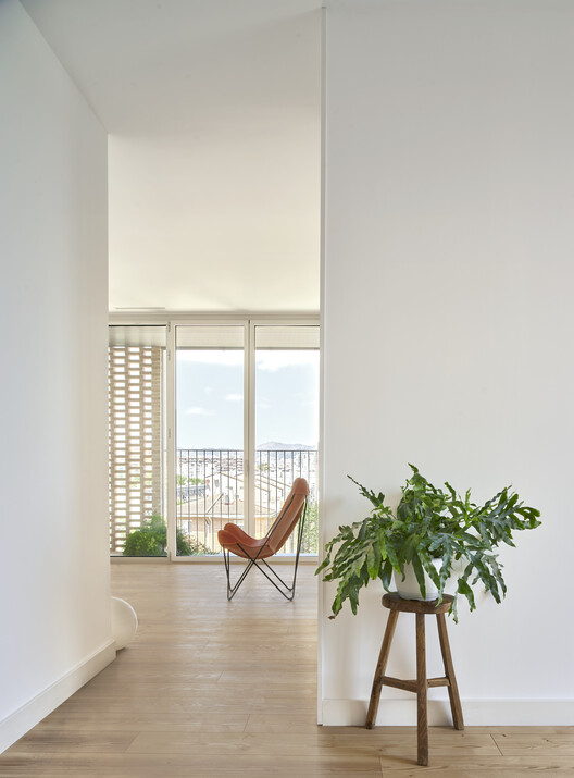 Social Atrium — 54 Social Housing Units in Besòs / Peris+Toral.arquitectes Social Atrium — 54 Social Housing Units in Besòs / Peris+Toral.arquitectes - Interior Photography, Wood, Chair