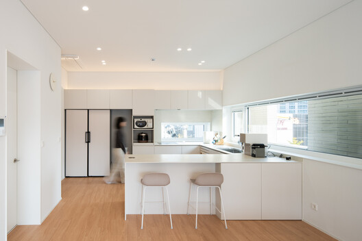 JH Gwangan Mixed-use building  / U.GA Architects - Interior Photography, Kitchen, Countertop, Wood, Lighting, Chair