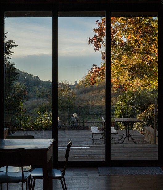 An unfinished domestic device as a threshold between interior and landscape / EX. An unfinished domestic device as a threshold between interior and landscape / EX. - Exterior Photography, Wood, Chair, Glass